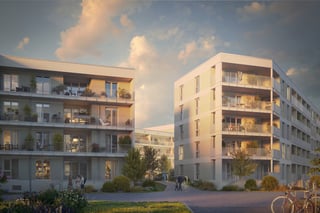 Außenansicht des Neubauprojekts am Freisinger Anger von KWAG: moderne Wohngebäude mit klarer Architektur, begrünten Fassaden und großzügigen Außenbereichen in städtischer Umgebung.